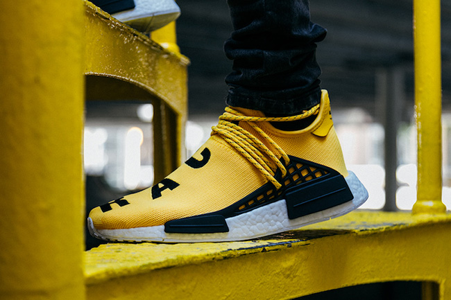 yellow and black human race sneakers
