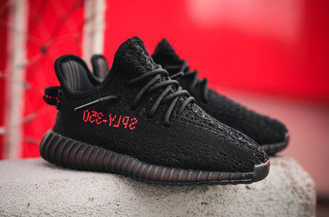 black yeezys with red writing