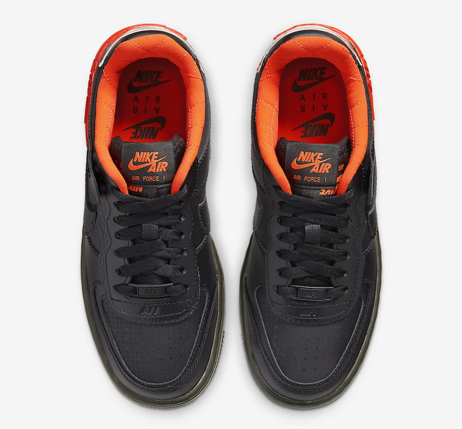 black nike shoes with orange swoosh
